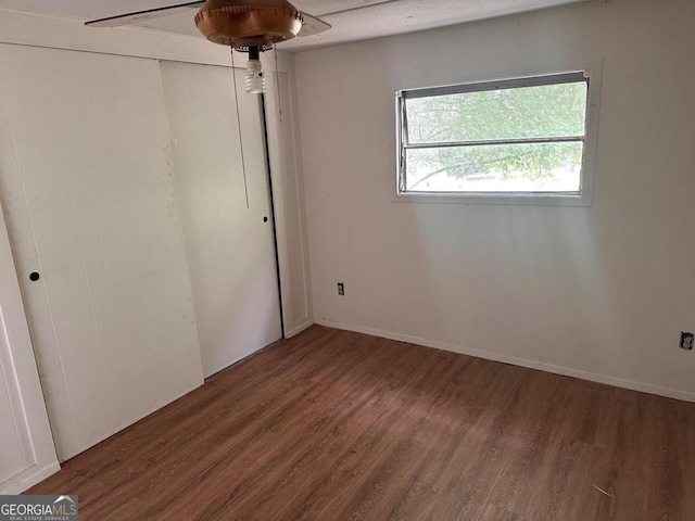 spare room with dark wood-type flooring