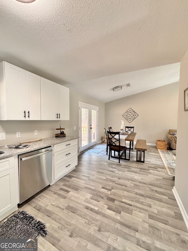 kitchen featuring white cabinetry, dishwasher, light stone countertops, french doors, and light wood-type flooring