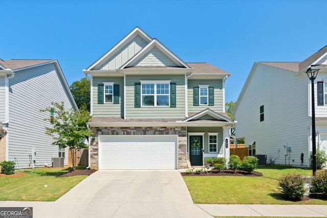 craftsman house featuring a garage, a front yard, and central AC unit