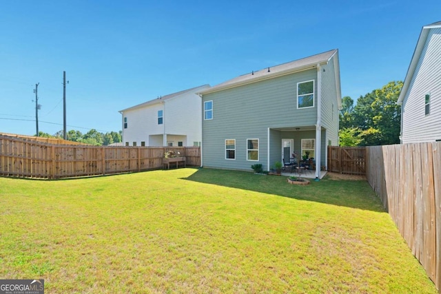 back of property featuring a patio area and a lawn