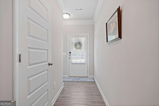 entryway featuring hardwood / wood-style flooring and ornamental molding