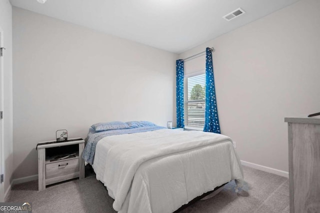 bedroom with light colored carpet