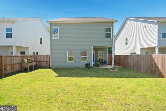 rear view of property featuring a patio area and a yard