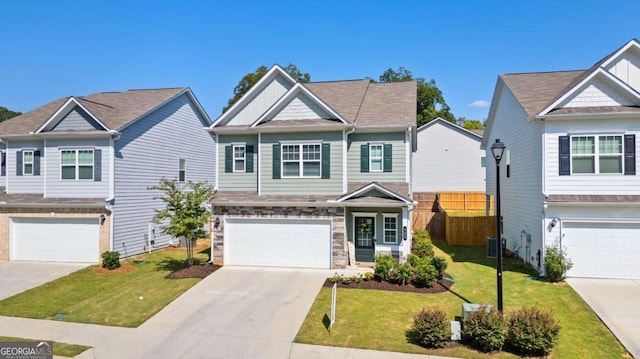 view of front of home featuring a garage, cooling unit, and a front yard