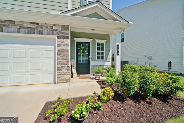 entrance to property featuring a garage and central AC