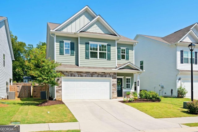 craftsman-style house with a garage, a front lawn, and central air condition unit