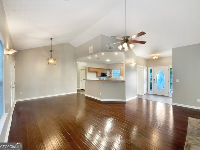 unfurnished living room with vaulted ceiling, wood-type flooring, and ceiling fan