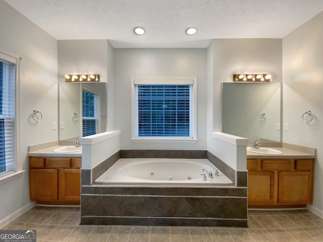 bathroom featuring vanity, tiled tub, and tile patterned floors