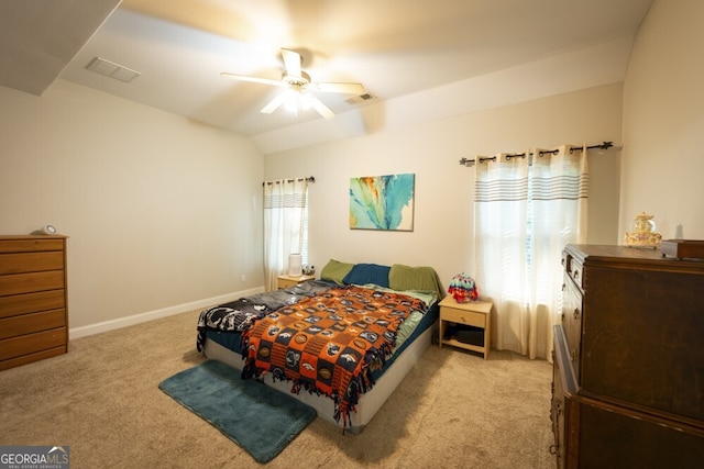 carpeted bedroom with vaulted ceiling and ceiling fan