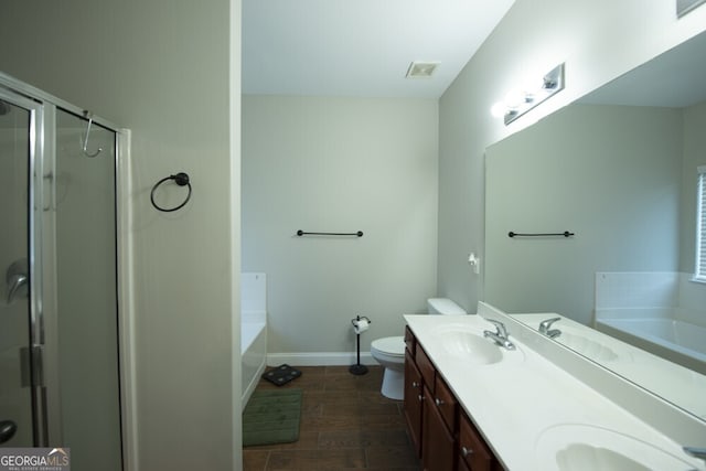 full bathroom featuring toilet, hardwood / wood-style flooring, separate shower and tub, and vanity