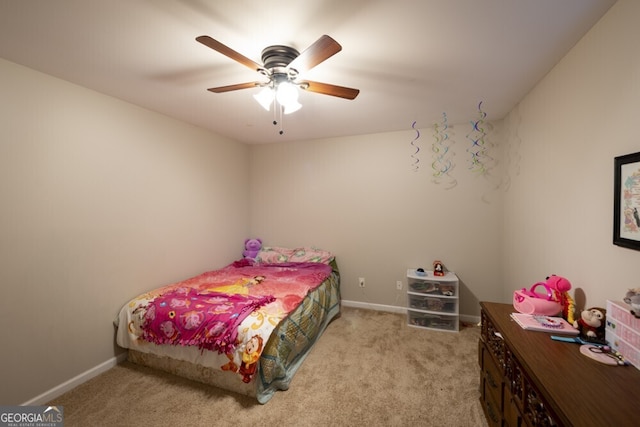 bedroom featuring light colored carpet and ceiling fan