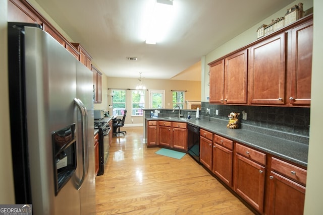 kitchen with backsplash, stainless steel appliances, light hardwood / wood-style floors, kitchen peninsula, and pendant lighting