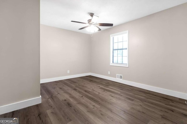 unfurnished room with ceiling fan and dark hardwood / wood-style flooring