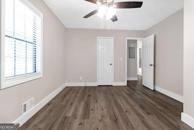 unfurnished bedroom with dark wood-type flooring and ceiling fan