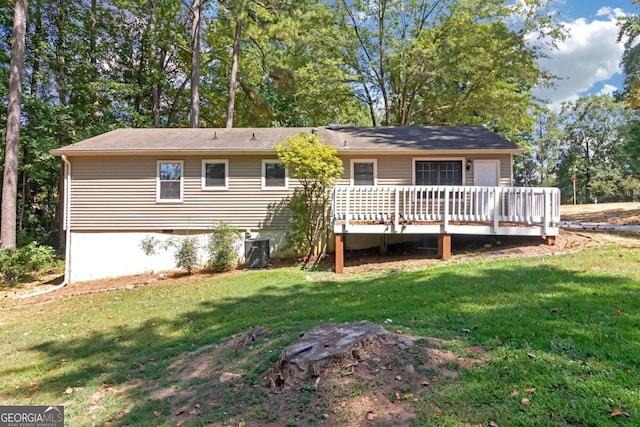 back of property featuring a wooden deck, a yard, and cooling unit