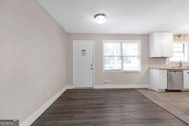 interior space with plenty of natural light, sink, and light hardwood / wood-style flooring