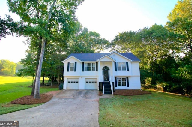 raised ranch featuring a garage and a front yard