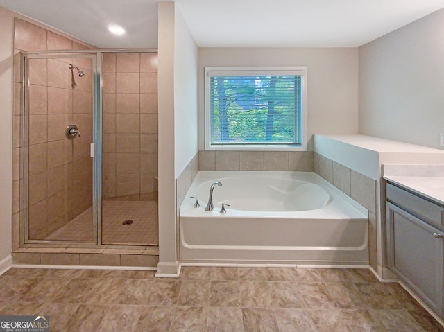 bathroom featuring vanity, separate shower and tub, and tile patterned floors