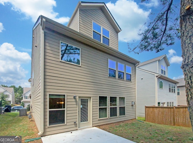 rear view of house featuring a yard and a patio