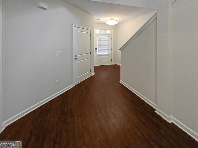 corridor featuring dark hardwood / wood-style flooring