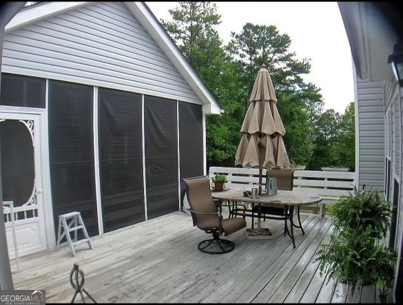 wooden deck with a sunroom