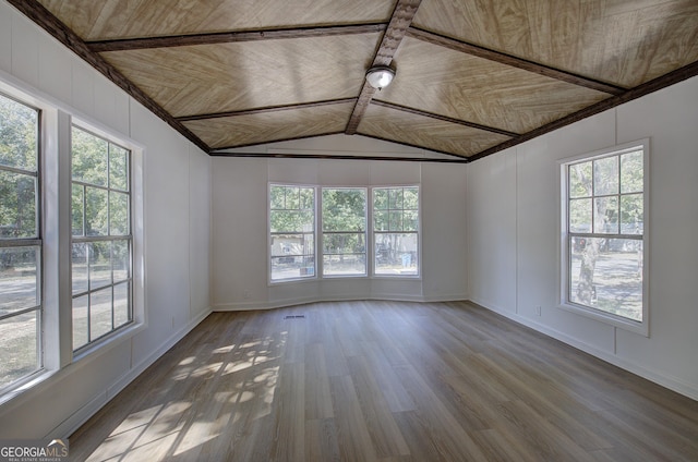 empty room with vaulted ceiling, wood ceiling, and wood finished floors