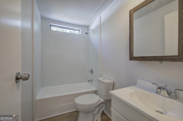 bathroom with vanity, wood finished floors, toilet, and washtub / shower combination