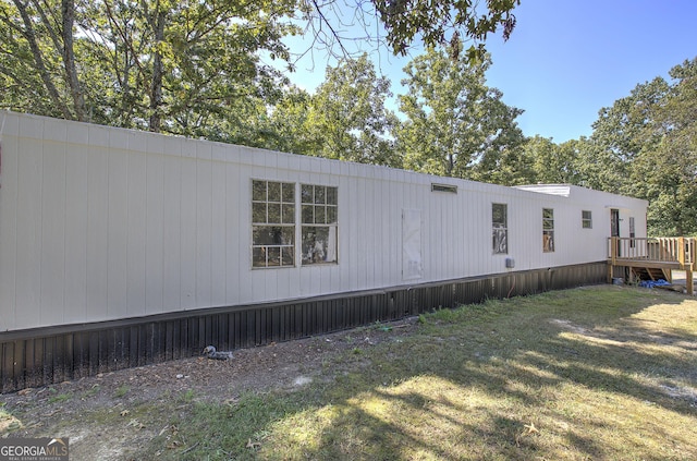 view of side of home with a yard