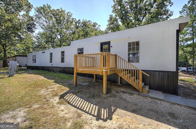 back of house featuring a wooden deck