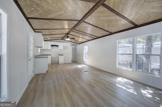 interior space featuring light wood finished floors, a ceiling fan, wood ceiling, and lofted ceiling