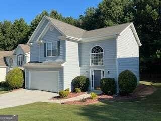 view of front of property with a garage and a front lawn