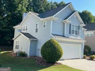 view of front of house with a garage and a front lawn