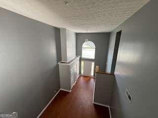 corridor with dark hardwood / wood-style floors