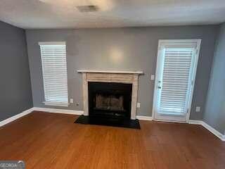 unfurnished living room featuring hardwood / wood-style flooring