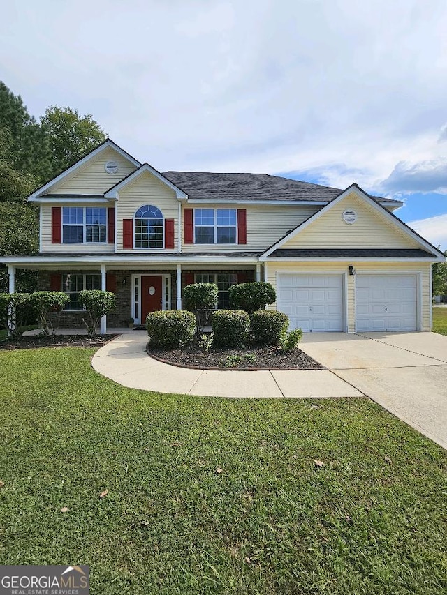 view of front of home featuring a porch, a front yard, and a garage