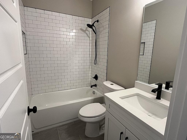 full bathroom featuring tiled shower / bath combo, vanity, tile patterned flooring, and toilet