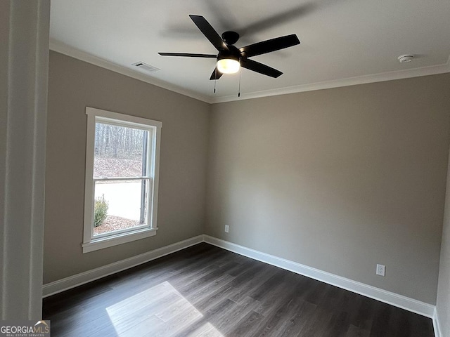 empty room with crown molding, dark wood-type flooring, and ceiling fan