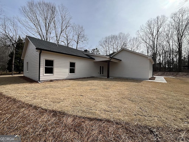 back of house with a yard