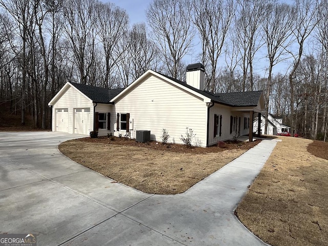 view of home's exterior featuring a garage and central air condition unit