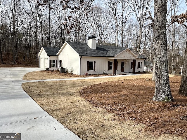 modern farmhouse featuring a garage, central AC, and a porch