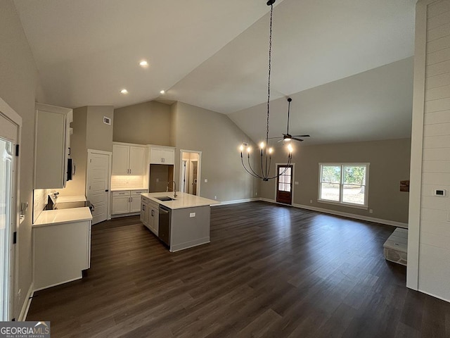 kitchen featuring sink, decorative light fixtures, dark hardwood / wood-style floors, a kitchen island with sink, and white cabinets