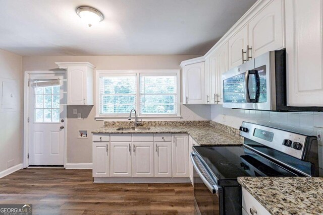 kitchen featuring stainless steel appliances, dark hardwood / wood-style flooring, white cabinetry, and sink