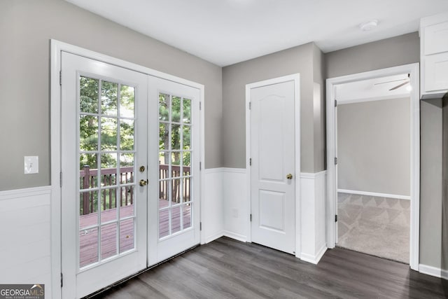 doorway to outside featuring dark wood-style floors, french doors, and wainscoting