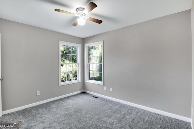 spare room featuring baseboards, visible vents, ceiling fan, and carpet flooring