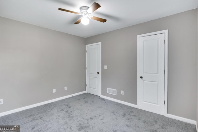 unfurnished bedroom featuring a ceiling fan, carpet flooring, visible vents, and baseboards