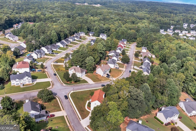 bird's eye view featuring a residential view and a wooded view