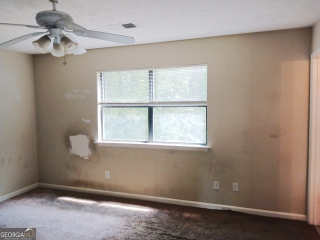 carpeted empty room with a healthy amount of sunlight and ceiling fan