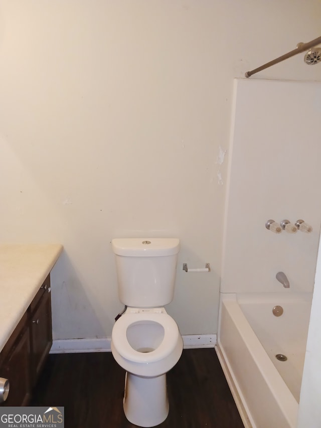 full bathroom with shower / bathing tub combination, vanity, toilet, and hardwood / wood-style floors