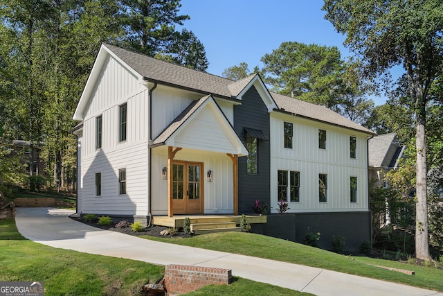 modern farmhouse featuring french doors and a front lawn