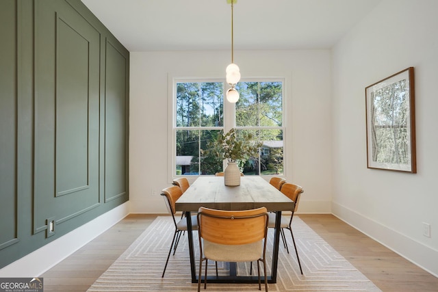 dining room with baseboards and light wood finished floors